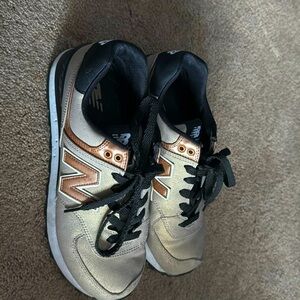 New balance 574 Gold black lace up sneakers.